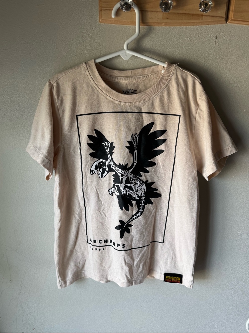 Official Pokémon Fossil Museum Archeops Skeleton Graphic T-Shirt Beige Youth S